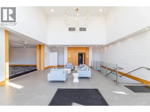 Bright resort lounge with seating and expansive windows. at 15 PARK Place Unit# 209, Osoyoos
