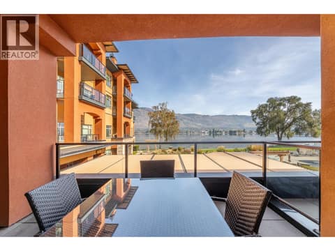 Covered balcony dining area overlooking the waterfront resort setting. at 15 PARK Place Unit# 209, Osoyoos