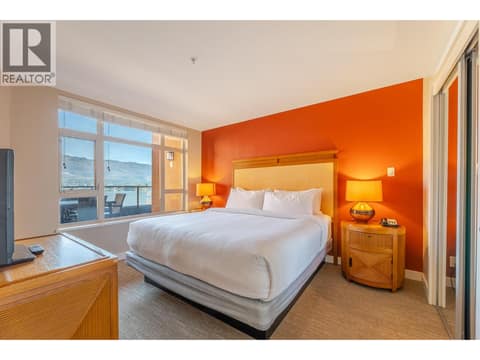 Furnished bedroom with window overlooking the resort and lake setting. at 15 PARK Place Unit# 209, Osoyoos