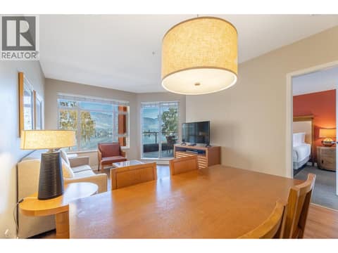 Furnished dining space with views toward the living room and balcony. at 15 PARK Place Unit# 209, Osoyoos