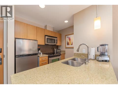 Kitchen peninsula with double sink and full-size appliances. at 15 PARK Place Unit# 209, Osoyoos