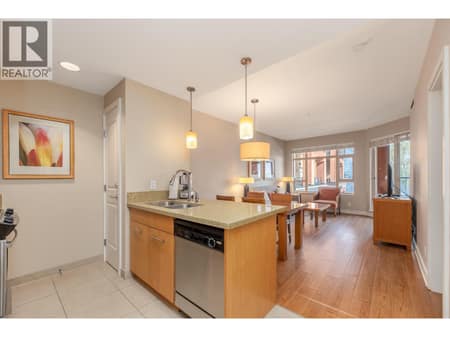 Open kitchen with sightlines through the dining and living areas. at 15 PARK Place Unit# 209, Osoyoos