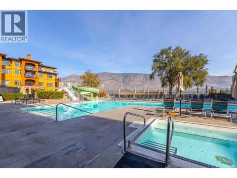 Resort pool deck with surrounding mountain backdrop. at 15 PARK Place Unit# 209, Osoyoos