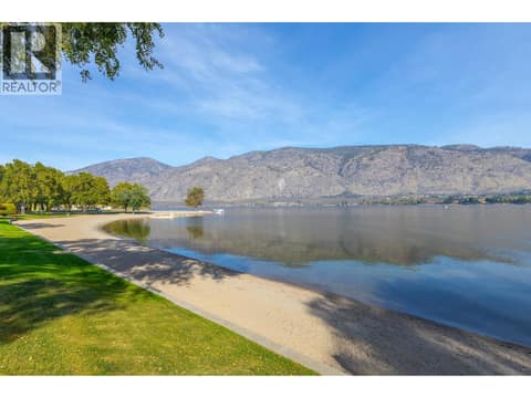 Sandy shoreline, calm Osoyoos Lake and surrounding mountains. at 15 PARK Place Unit# 209, Osoyoos