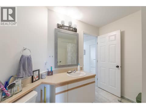 Bathroom vanity area with storage, mirror and overhead lighting. at 145 REDWING Place Unit# 7, Oliver