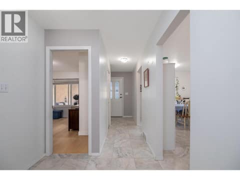 Central hall provides access to the bedrooms, bathroom, entry and dining area. at 145 REDWING Place Unit# 7, Oliver
