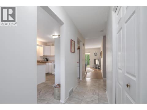 Central hallway connects the entry and kitchen with the living area beyond. at 145 REDWING Place Unit# 7, Oliver