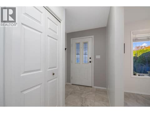 Front foyer with tiled flooring, nearby storage and a window beside the entry. at 145 REDWING Place Unit# 7, Oliver
