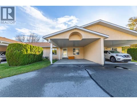 Front view highlights the covered parking area and approach to the entry. at 145 REDWING Place Unit# 7, Oliver