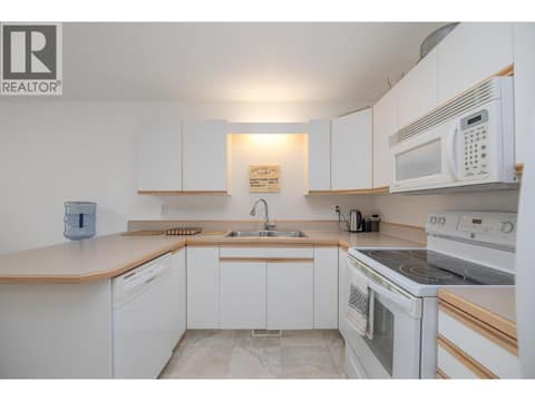 Kitchen view highlighting the sink, appliances, cabinetry and counter space. at 145 REDWING Place Unit# 7, Oliver