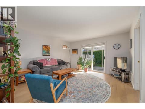 Living room overview with a sliding door opening to the covered patio. at 145 REDWING Place Unit# 7, Oliver