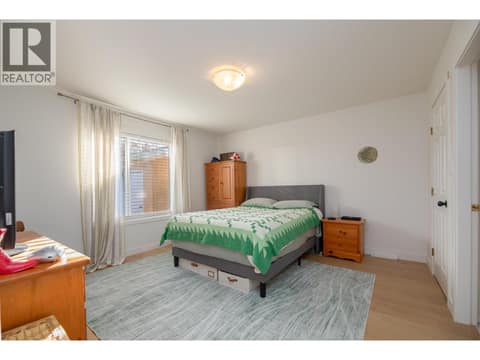 Primary bedroom with a large window and room for multiple furniture pieces. at 145 REDWING Place Unit# 7, Oliver