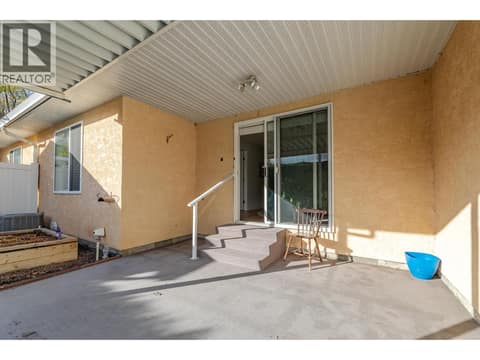 Rear patio and sliding door create a sheltered outdoor connection to the living room. at 145 REDWING Place Unit# 7, Oliver