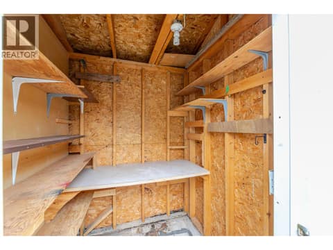 Shed interior includes open shelving and a work surface. at 145 REDWING Place Unit# 7, Oliver