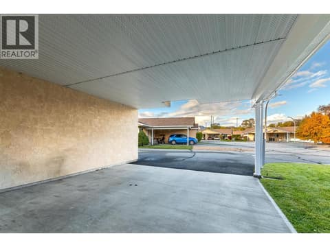 View from beneath the covered parking area toward the residential lane. at 145 REDWING Place Unit# 7, Oliver