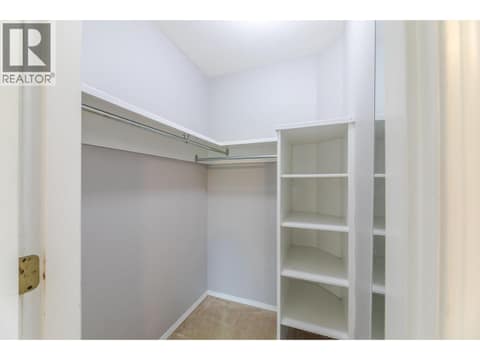 Walk-in closet with hanging space and built-in open shelving. at 145 REDWING Place Unit# 7, Oliver