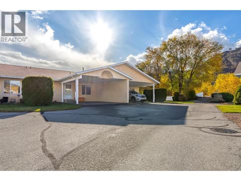 Wider exterior view places Unit 7 within the surrounding residential setting. at 145 REDWING Place Unit# 7, Oliver